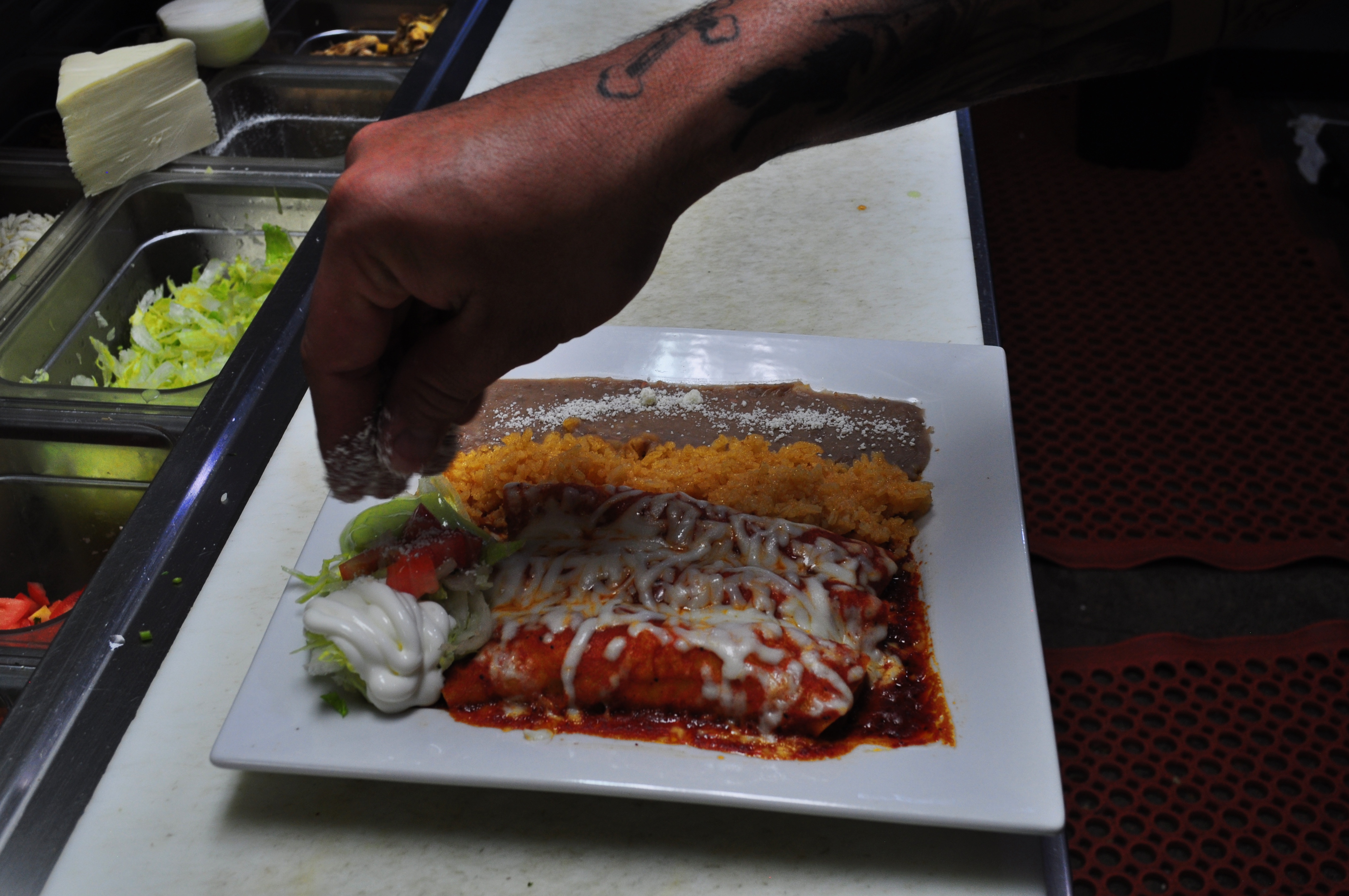 A cook plating fresh Mexican food at Taqueria Portland